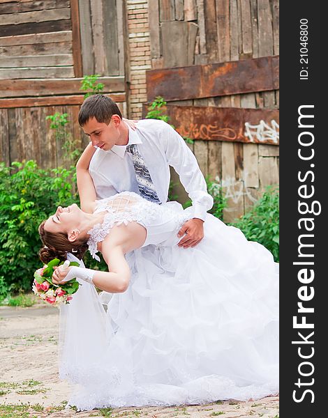 Bride and groom dancing outdoor