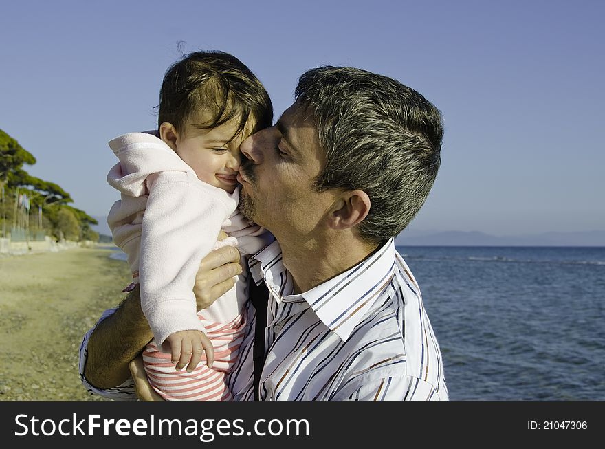 Baby With Her Father On The Beach