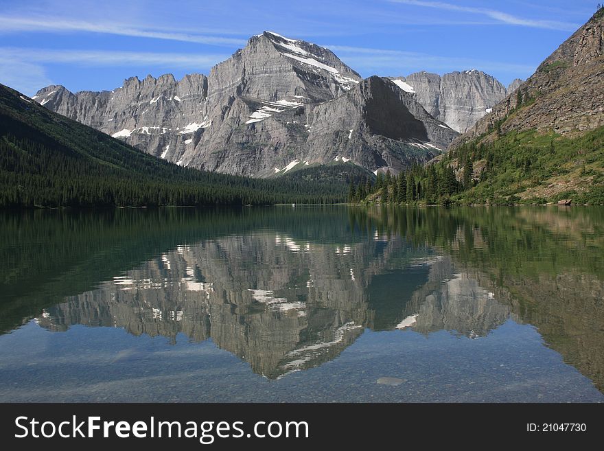 Mountain with its reflection in a glacial lake in Glacier National Park. Mountain with its reflection in a glacial lake in Glacier National Park