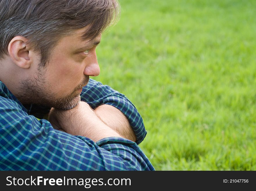 Portrait of a cute man lying on a grass. Portrait of a cute man lying on a grass
