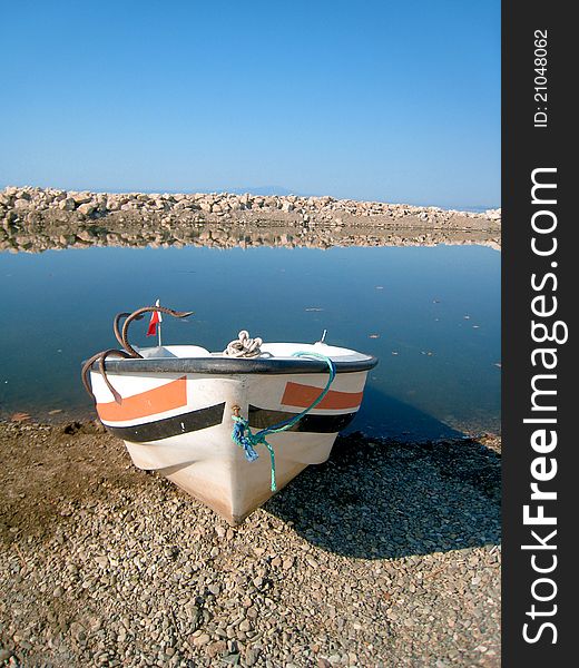 Old fish-boat on sand beach.