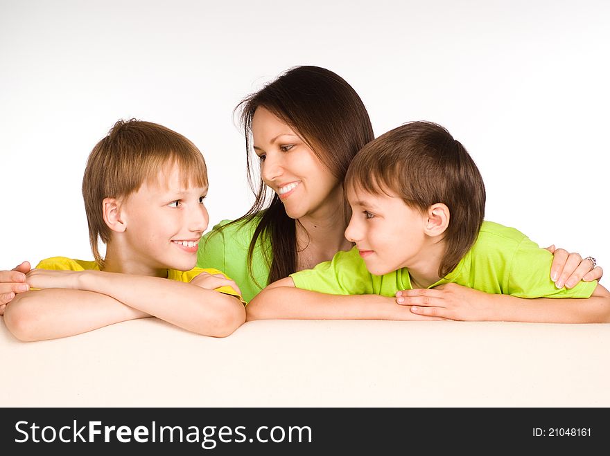 Cute mom with her little boys on sofa. Cute mom with her little boys on sofa