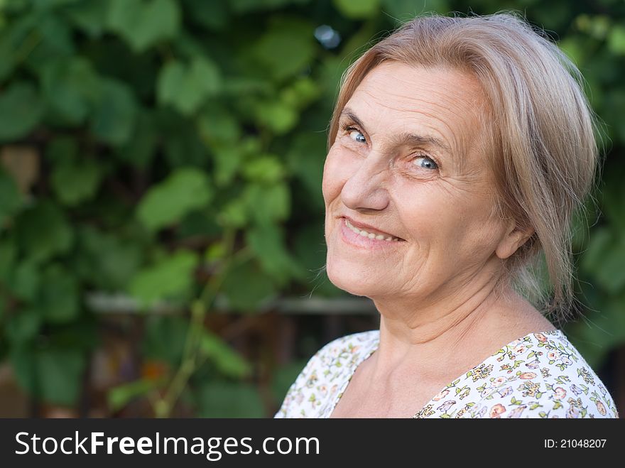 Portrait of a cute aged woman at nature. Portrait of a cute aged woman at nature