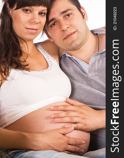 Portrait of a nice pregnant couple on a white. Portrait of a nice pregnant couple on a white