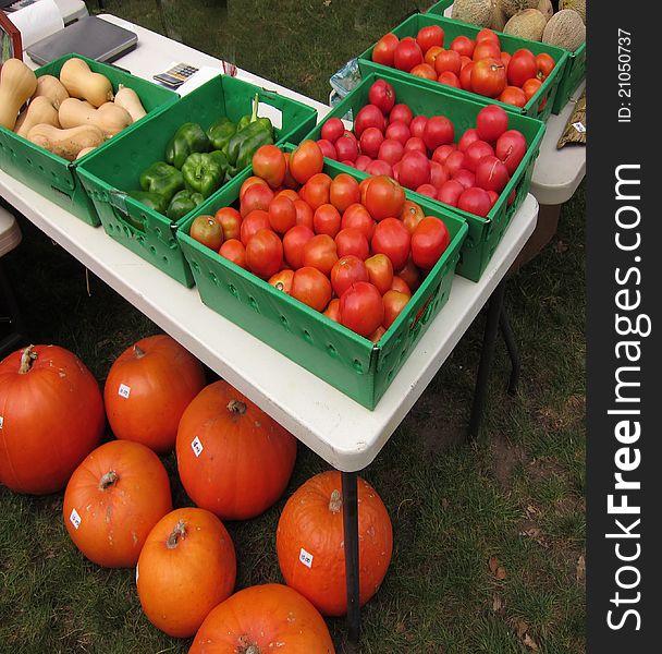 This is a photo of a farm stand table with variuos vegetables.