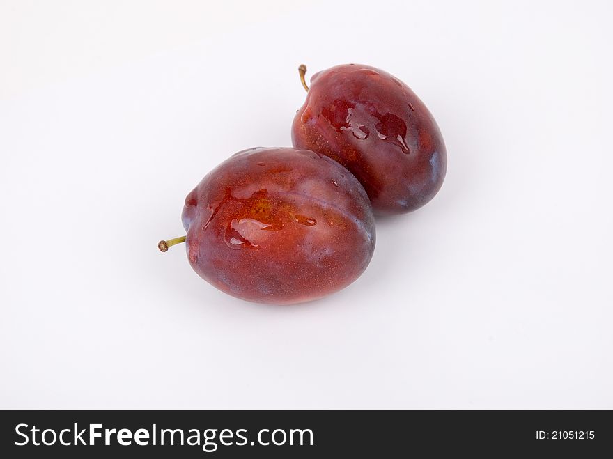 Two plums on a white background in studio