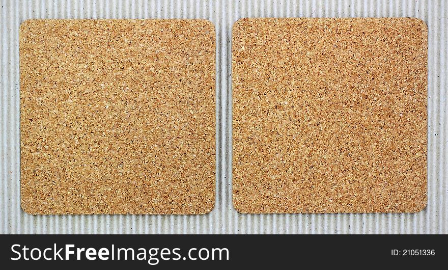Two blank corkboards on corrugated paper for background