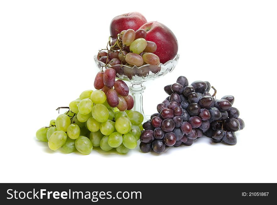 Fruits in glass vase on white background