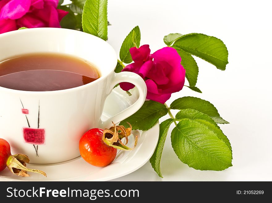 Rosehip tea on the background of fruits and flowers. Rosehip tea on the background of fruits and flowers