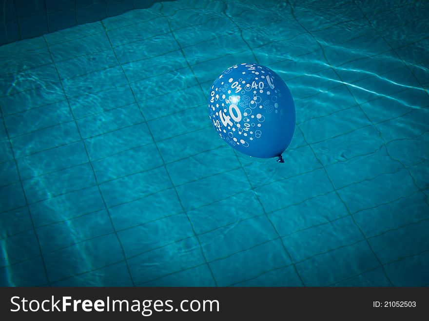 Blue balloon with numbers on in swimming pool. Blue balloon with numbers on in swimming pool