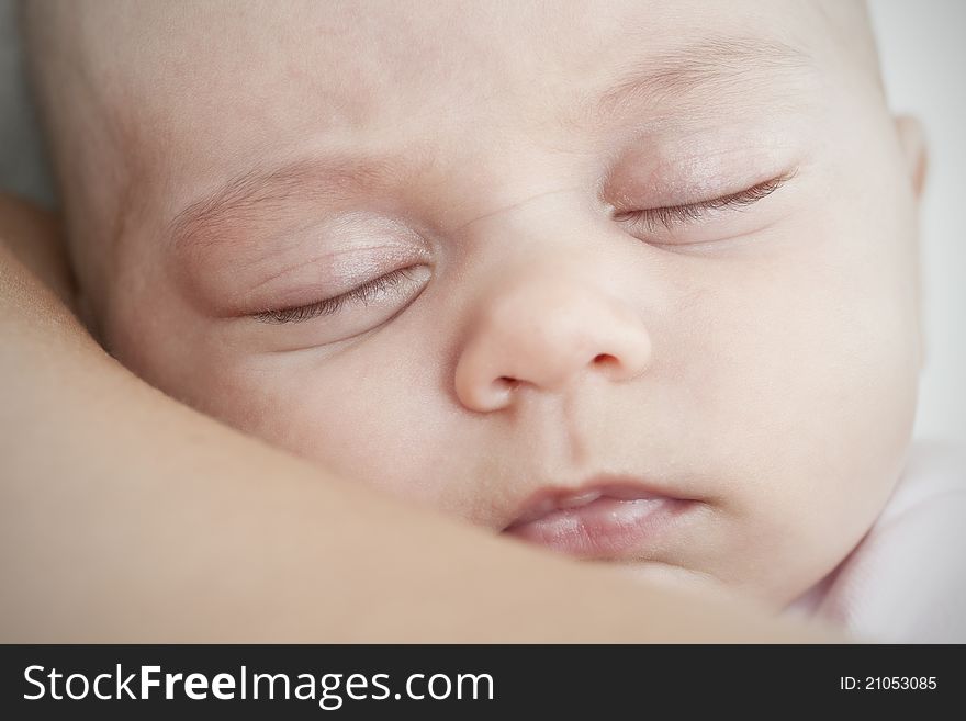 Baby sleeping on his mother's shoulder, high light and white background. Baby sleeping on his mother's shoulder, high light and white background