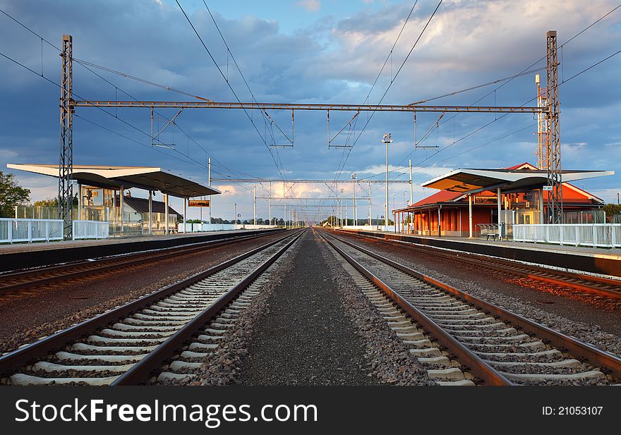 Passenger train station with clouds