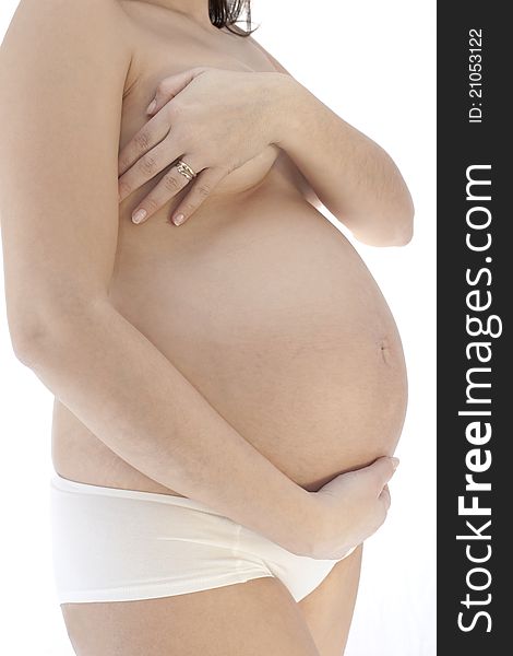 Belly of pregnant woman with hands on the breast on white background. Belly of pregnant woman with hands on the breast on white background
