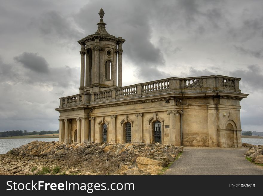 Ancient Normanton chapel on shores of a lake in the uk