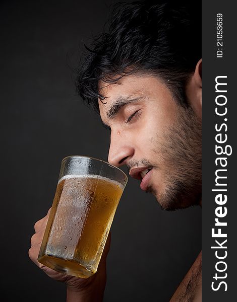 Indian Man drinking beer  from beer mug