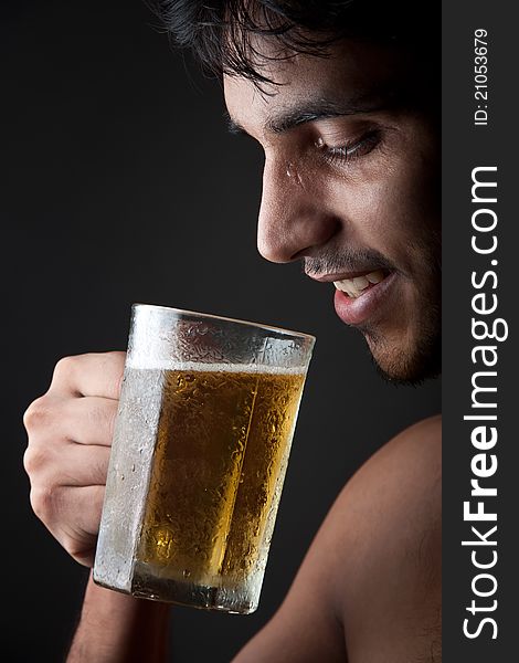Indian Man drinking beer  from beer mug