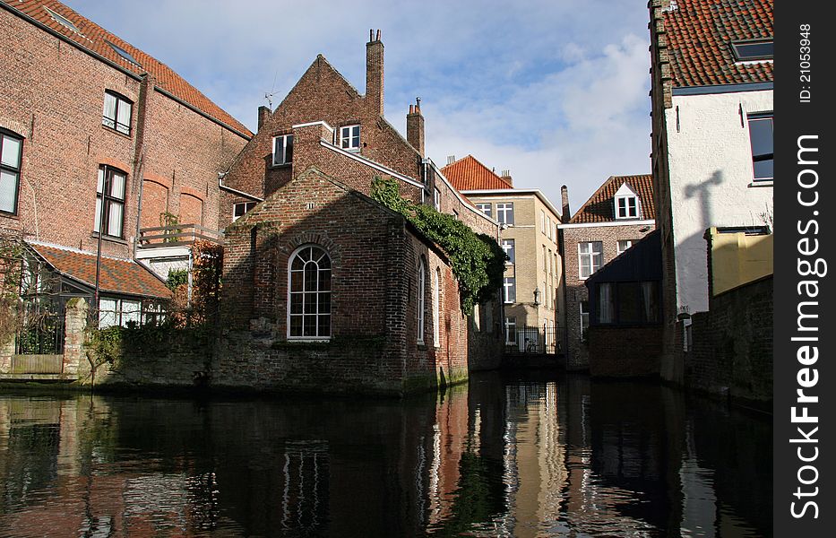 Reflected Bruges houses, canal view - The Belfry behind rosary dock is 83 metres high and date from XIIIth century.