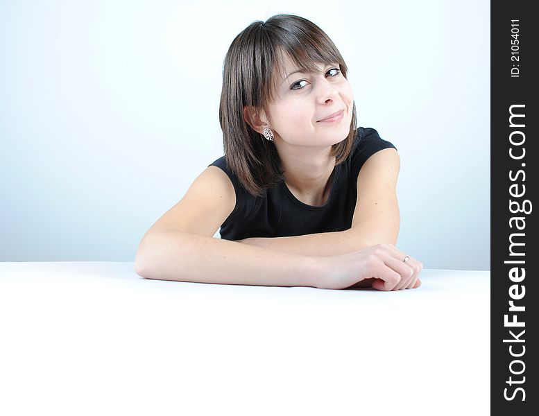 Young woman leaning on a table