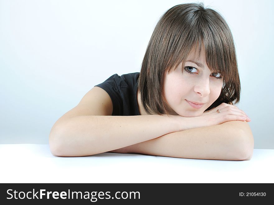 Young woman leaning on a table