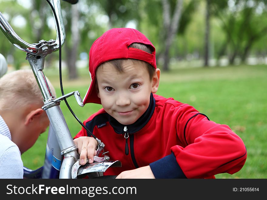 Boy on a bicycle in the green park