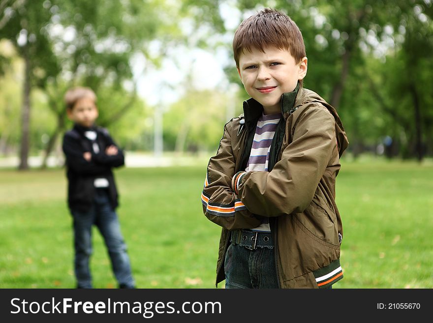 Happy smiling boy with a friend in the green park