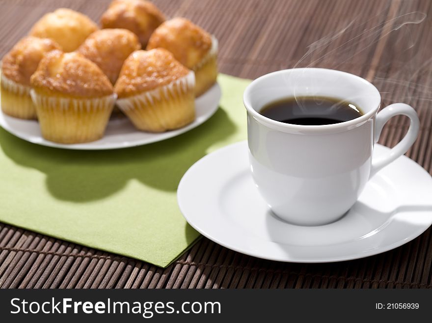 A breakfast with a cup of hot coffee and muffins!. A breakfast with a cup of hot coffee and muffins!