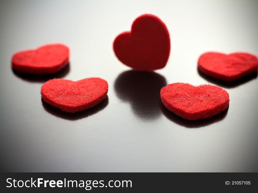 Five red hearts on a gray background. Five red hearts on a gray background.