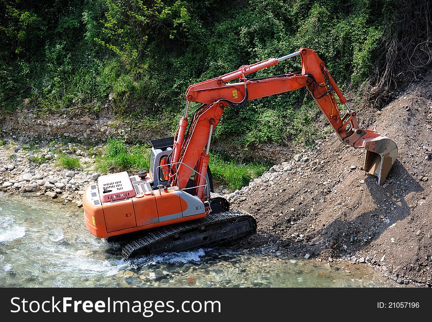 Excavator In The River