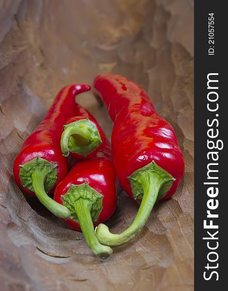 Red hot chili peppers on old wooden background