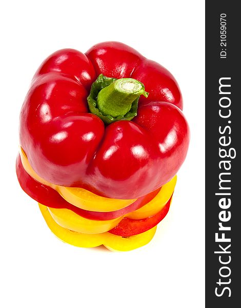 Slices of red and yellow sweet peppers stacked together on a white. Slices of red and yellow sweet peppers stacked together on a white
