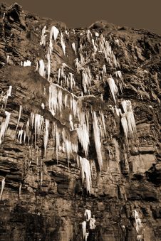Cascade Of Icicles On A Cliff Face In Sepia Royalty Free Stock Photos