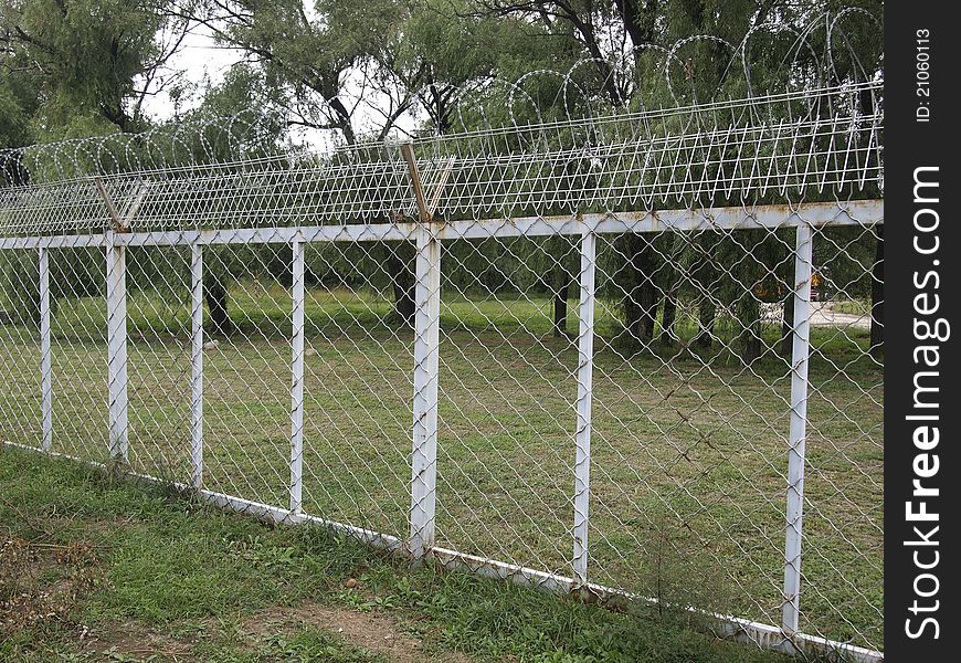Protection iron fence with barbed wire. Protection iron fence with barbed wire.