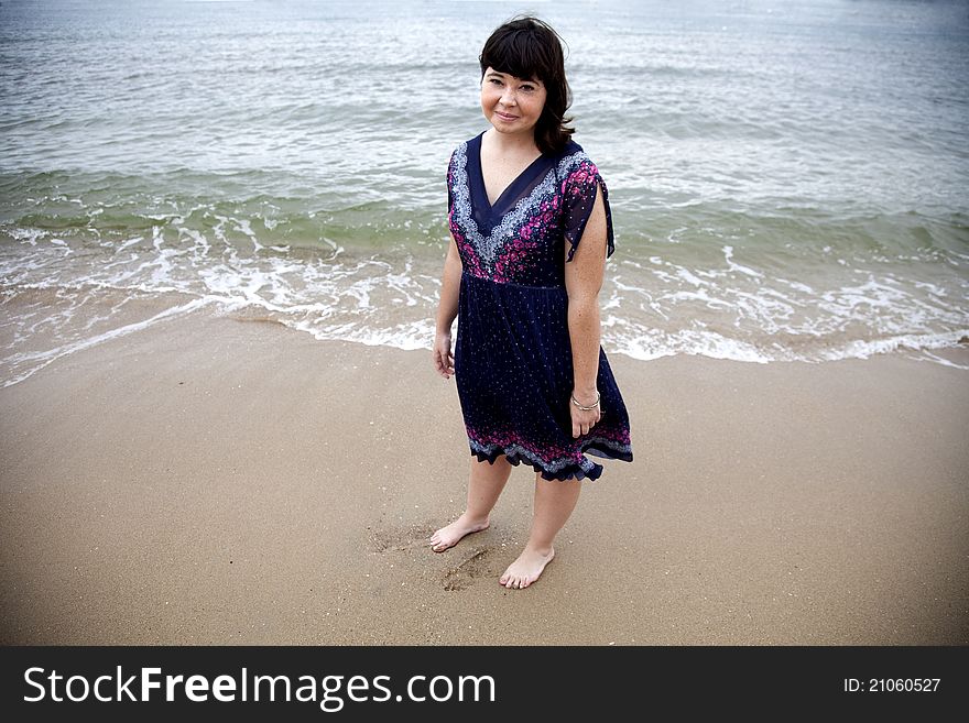 A portrait of a young girl on the beach.
