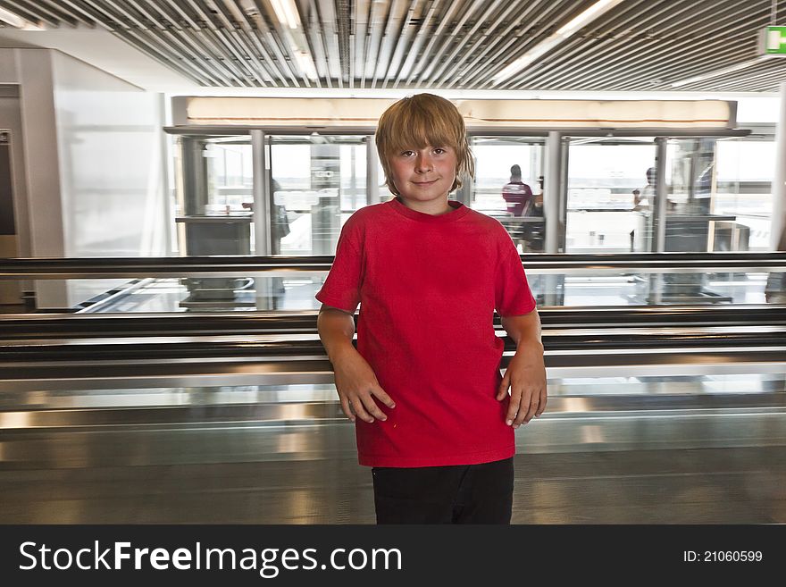 Boy on a moving staircase inside the airport