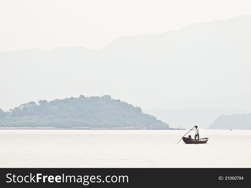 A fisherman on boat alone in the sea