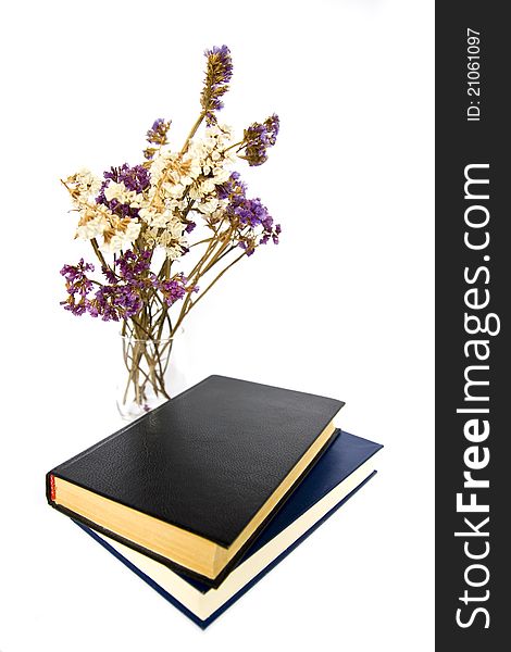 Dried flowers, and books on white background. Dried flowers, and books on white background