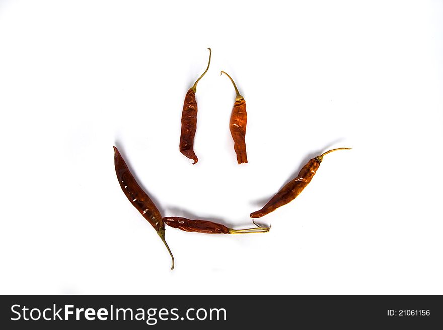 Red peppers laid out in a smile on a white background. Red peppers laid out in a smile on a white background