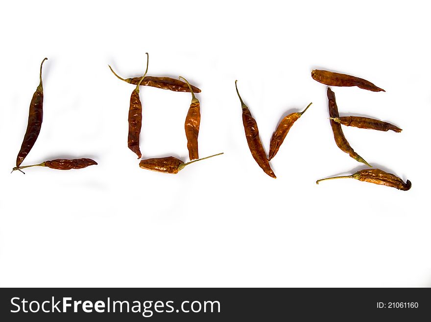 Red peppers laid out the word love on a white background. Red peppers laid out the word love on a white background