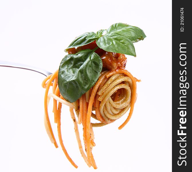 Spaghetti bolognese with basil leaves on a fork. Spaghetti bolognese with basil leaves on a fork