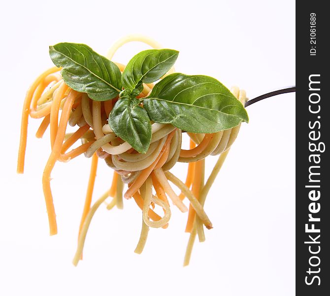 Spaghetti with basil leaves on a fork. Spaghetti with basil leaves on a fork