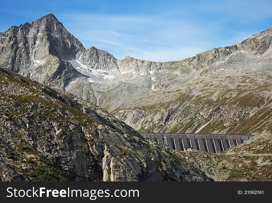 Dam and man-made lake between mountains. Itâ€™s Pantano Lake, North of Italy, Lombardy region, at 2.378 meters on the sea-level. Dam and man-made lake between mountains. Itâ€™s Pantano Lake, North of Italy, Lombardy region, at 2.378 meters on the sea-level
