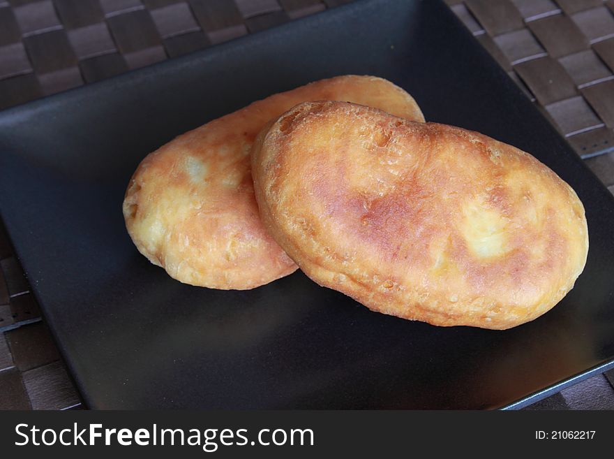 Two patties on dark plate