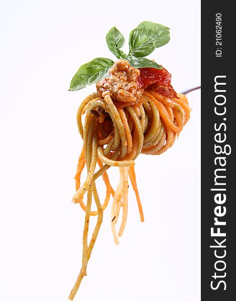 Spaghetti bolognese with basil leaves on a fork. Spaghetti bolognese with basil leaves on a fork