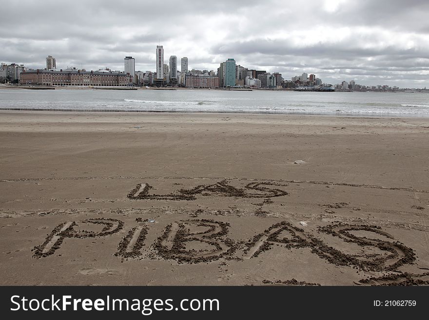 Cloudy beach day with a message written on the sand. Cloudy beach day with a message written on the sand