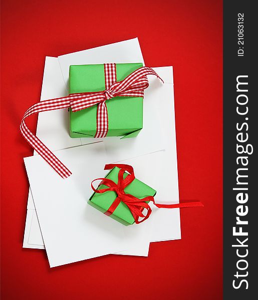 Christmas cards with Christmas presents on the red background. Paper with decorations and copy space