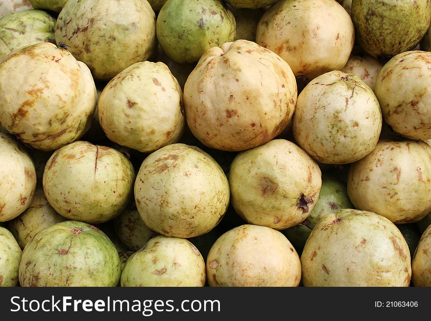 Pile of fresh ripe guavas on an indoor market