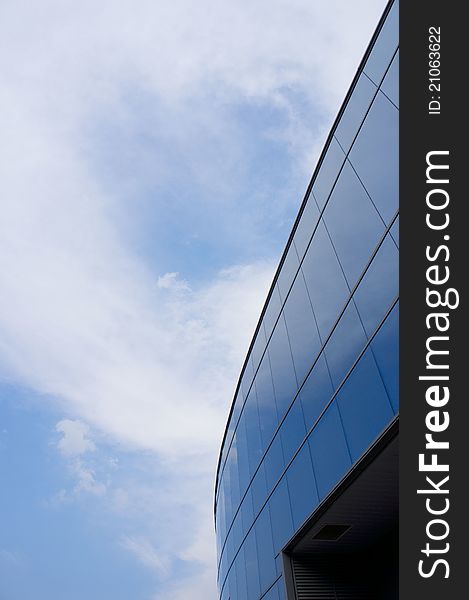 Blue Curve arc glass structure reflecting the clear sky. Blue Curve arc glass structure reflecting the clear sky