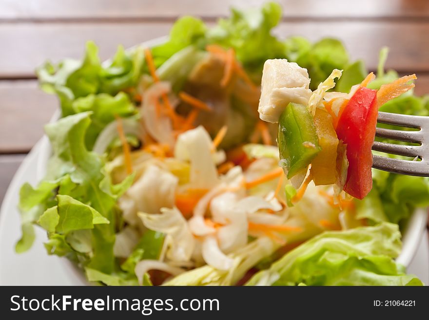 Closeup of fork with salad and chesse. Closeup of fork with salad and chesse