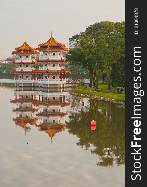 Twin Chinese pagodas with reflection in lake. Twin Chinese pagodas with reflection in lake.