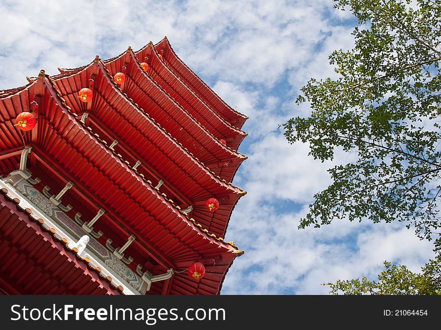 Tall Oriental Chinese pagoda against blue sky. Tall Oriental Chinese pagoda against blue sky.